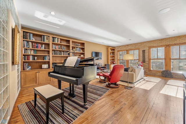 300 Broadway N Unit 204, Fargo, ND 58102 - living area with brick wall and light wood-style floors