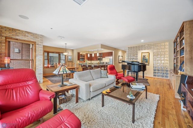300 Broadway N Unit 204, Fargo, ND 58102 - living area with light wood finished floors and brick wall
