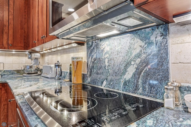 300 Broadway N Unit 204, Fargo, ND 58102 - kitchen with black electric cooktop, backsplash, and stone countertops