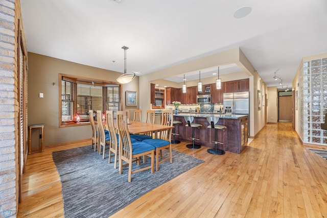 300 Broadway N Unit 204, Fargo, ND 58102 - dining area with light wood finished floors and baseboards