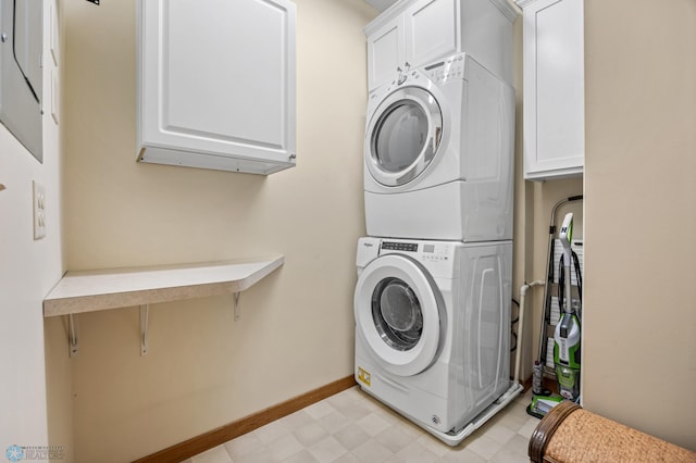 300 Broadway N Unit 204, Fargo, ND 58102 - laundry area with stacked washing machine and dryer, light flooring, cabinet space, and baseboards