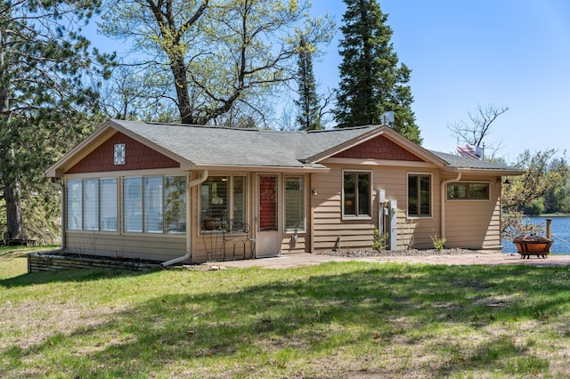 6363 Circle Rd, Danbury, WI 54830 - ranch-style home featuring roof with shingles, a front yard, a fire pit, and a chimney