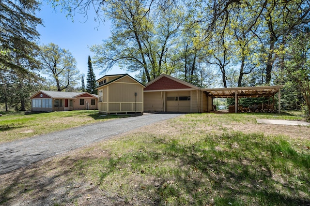 6363 Circle Rd, Danbury, WI 54830 - view of front of home featuring a front yard, asphalt driveway, and a garage