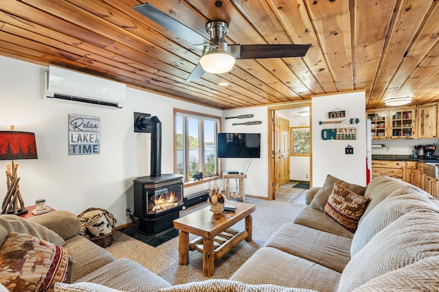6363 Circle Rd, Danbury, WI 54830 - living area with an AC wall unit, wooden ceiling, a wood stove, light colored carpet, and a ceiling fan