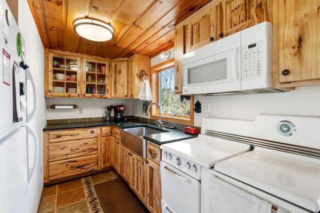 6363 Circle Rd, Danbury, WI 54830 - kitchen featuring white appliances, wood ceiling, a sink, glass insert cabinets, and washer and dryer