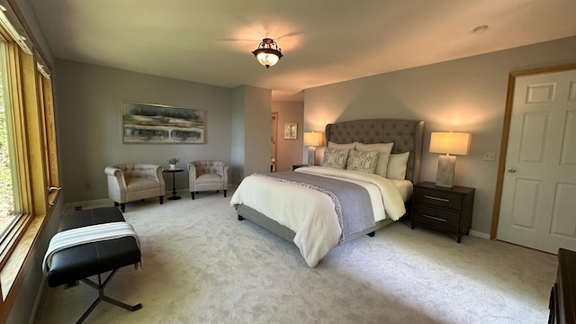 bedroom featuring baseboards and light carpet
