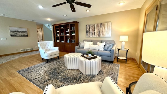 living room with ceiling fan, wood finished floors, baseboards, and recessed lighting