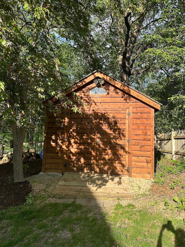 view of shed with fence
