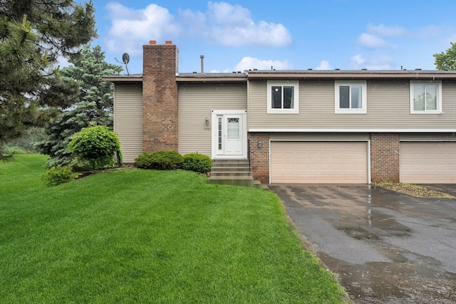 13967 Herald Ct, Apple Valley, MN 55124 - raised ranch featuring an attached garage, driveway, a front lawn, a chimney, and brick siding