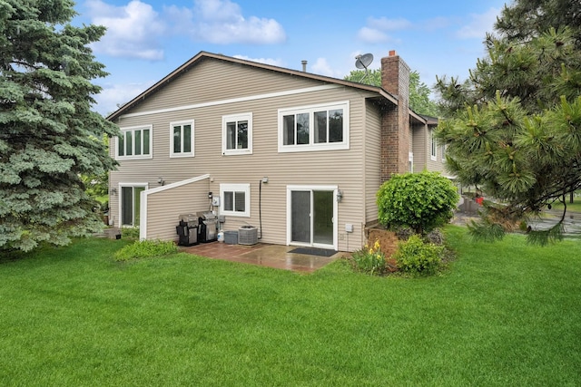 13967 Herald Ct, Apple Valley, MN 55124 - rear view of property with a chimney, a patio area, a lawn, and cooling unit