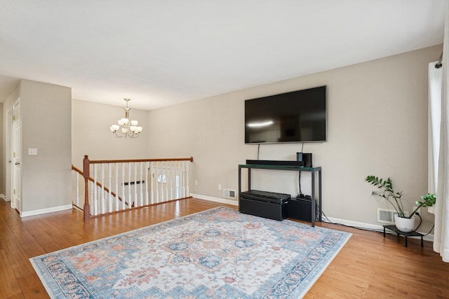13967 Herald Ct, Apple Valley, MN 55124 - living room featuring wood-type flooring, a chandelier, and baseboards