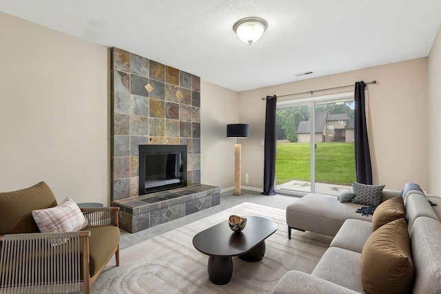 13967 Herald Ct, Apple Valley, MN 55124 - living area with a tiled fireplace, carpet flooring, and baseboards