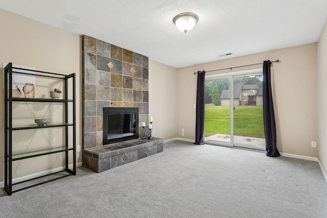 13967 Herald Ct, Apple Valley, MN 55124 - unfurnished living room with baseboards, a tile fireplace, carpet, and a textured ceiling
