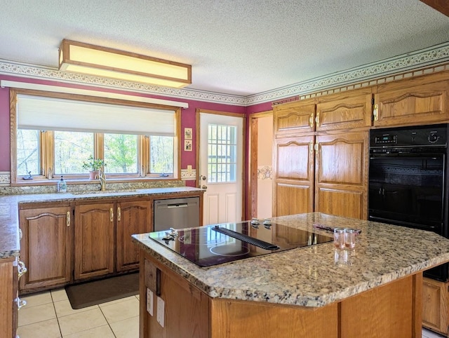 24944 State Highway 210, Mcgregor, MN 55760 - kitchen with black appliances, a sink, a center island, light tile patterned floors, and light stone counters