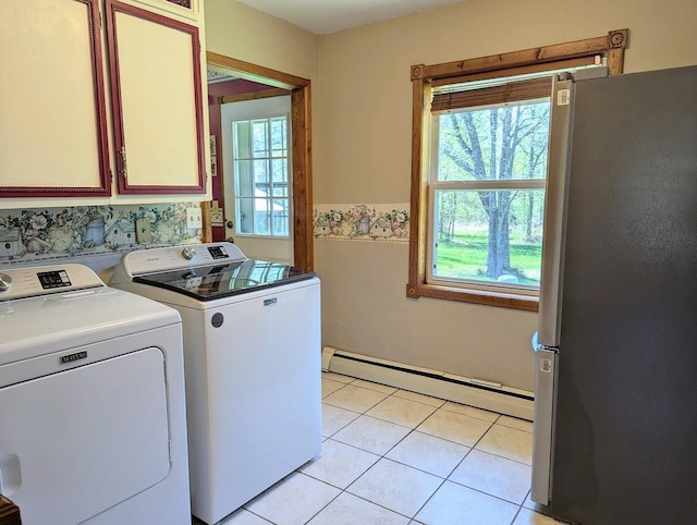 24944 State Highway 210, Mcgregor, MN 55760 - laundry area featuring a baseboard radiator, washer and clothes dryer, plenty of natural light, and cabinet space