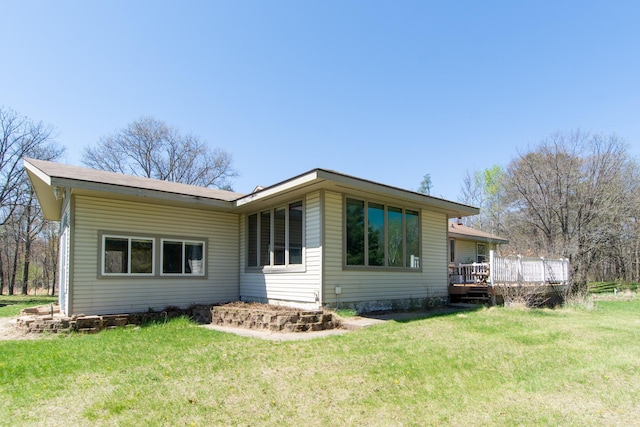 24944 State Highway 210, Mcgregor, MN 55760 - back of property featuring a wooden deck and a yard