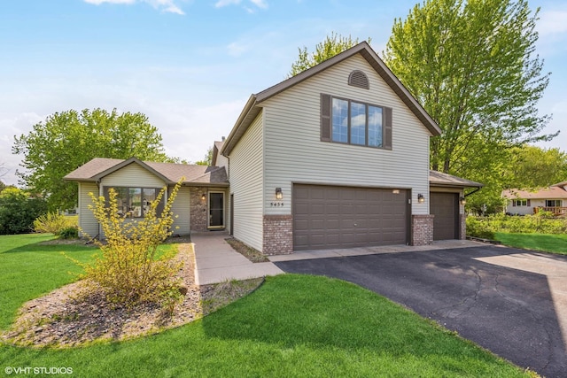 5435 274th St, Wyoming, MN 55092 - traditional-style house with brick siding, asphalt driveway, a front yard, and a garage