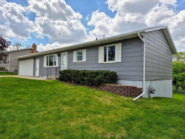 single story home with an attached garage, a front lawn, and a chimney