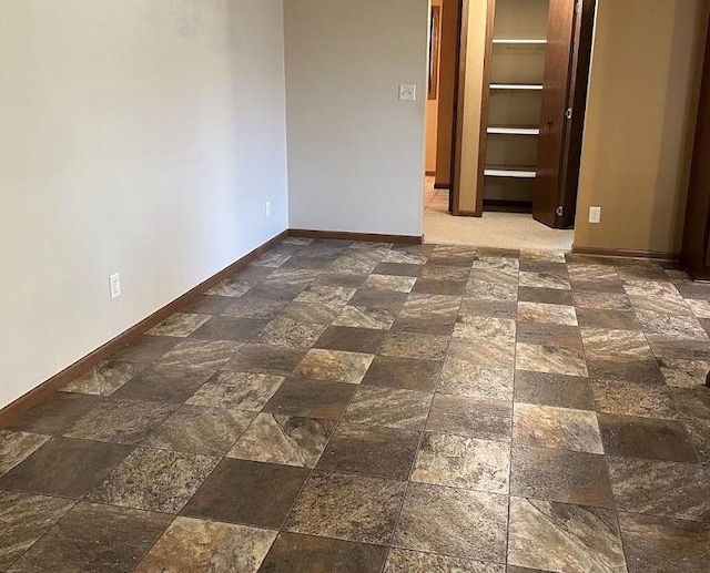 413 River Bluff Dr, Windom, MN 56101 - spare room featuring stone tile flooring and baseboards