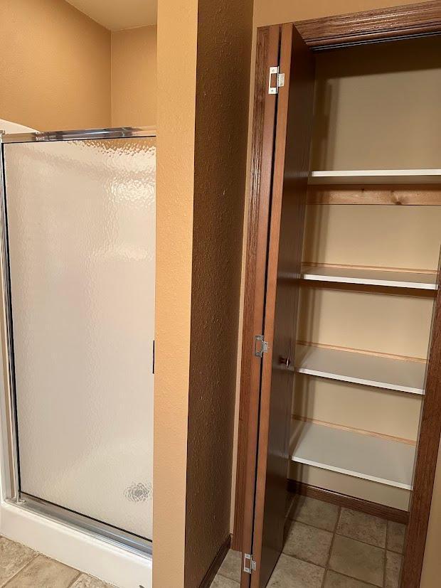 413 River Bluff Dr, Windom, MN 56101 - bathroom featuring a stall shower and tile patterned flooring