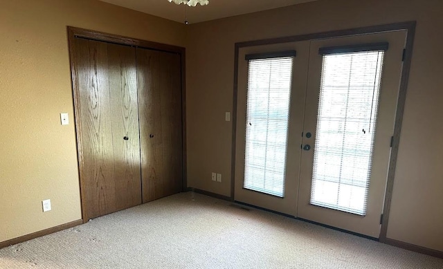 413 River Bluff Dr, Windom, MN 56101 - unfurnished bedroom with light carpet, french doors, and a closet