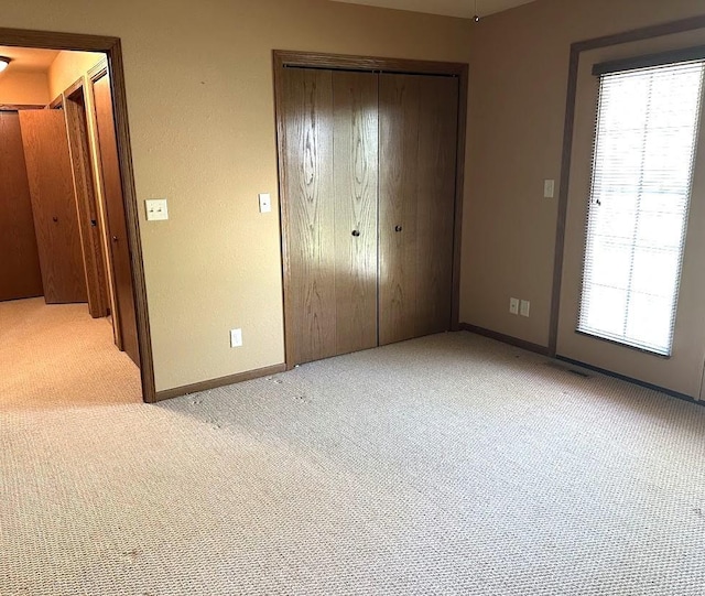 413 River Bluff Dr, Windom, MN 56101 - unfurnished bedroom featuring light carpet, a closet, and baseboards