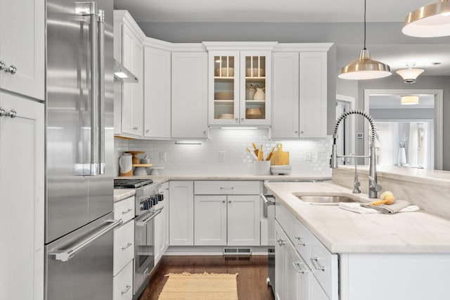 5220 Abbott Ave S, Minneapolis, MN 55410 - kitchen featuring high end appliances, white cabinets, dark wood-type flooring, and a sink