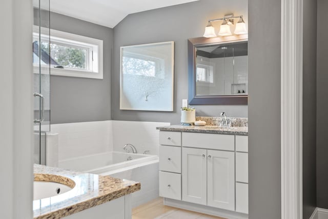 5220 Abbott Ave S, Minneapolis, MN 55410 - bathroom featuring vanity, a garden tub, a shower stall, and tile patterned flooring
