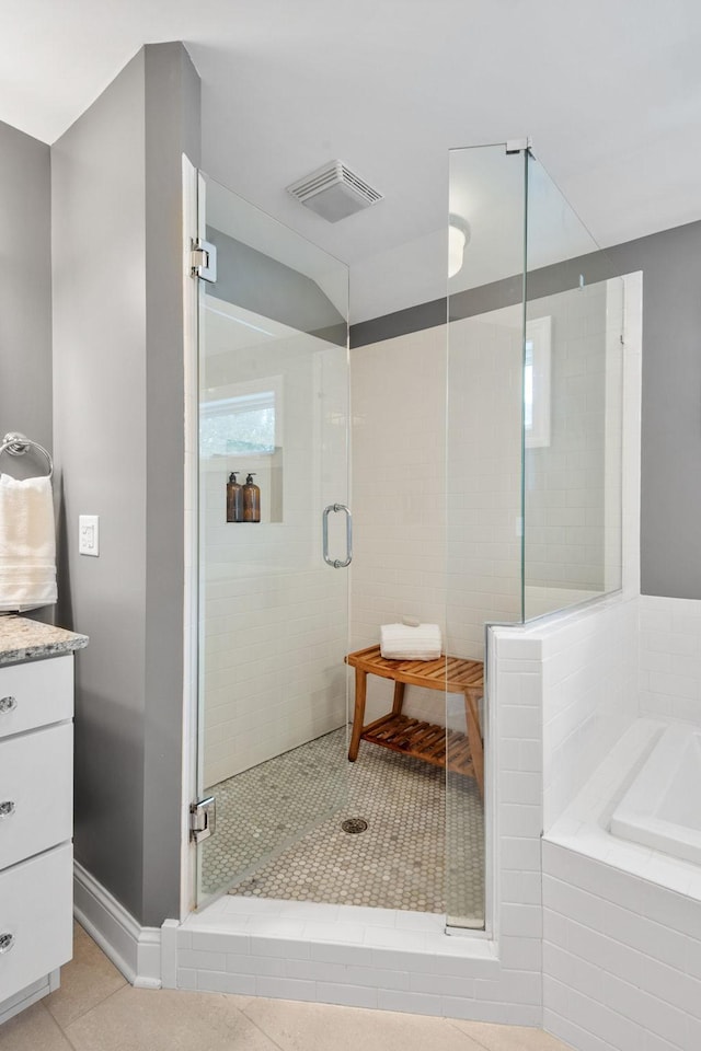 5220 Abbott Ave S, Minneapolis, MN 55410 - full bathroom with a stall shower, a garden tub, tile patterned floors, and vanity