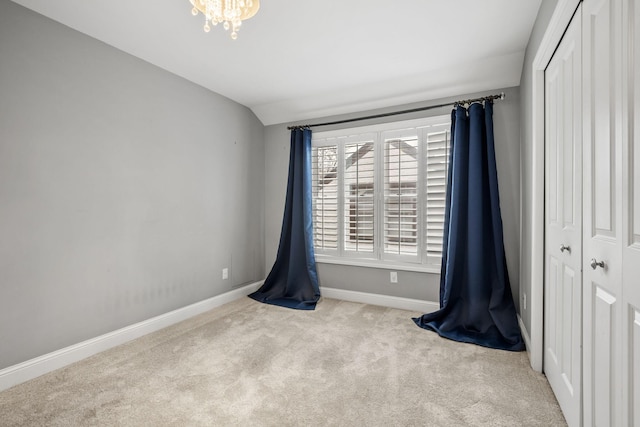 5220 Abbott Ave S, Minneapolis, MN 55410 - unfurnished bedroom with a closet, baseboards, carpet flooring, lofted ceiling, and a chandelier