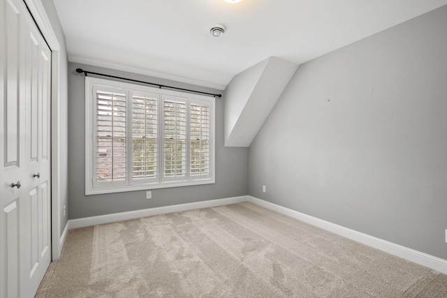 5220 Abbott Ave S, Minneapolis, MN 55410 - unfurnished bedroom with a closet, baseboards, carpet flooring, and lofted ceiling