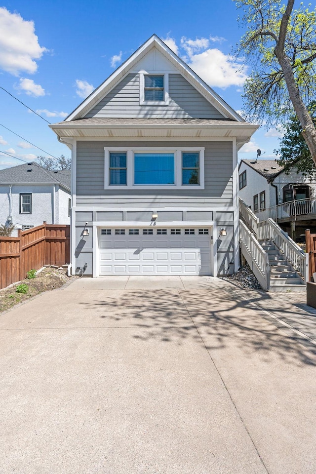 5220 Abbott Ave S, Minneapolis, MN 55410 - view of front facade featuring an attached garage, driveway, fence, and stairs