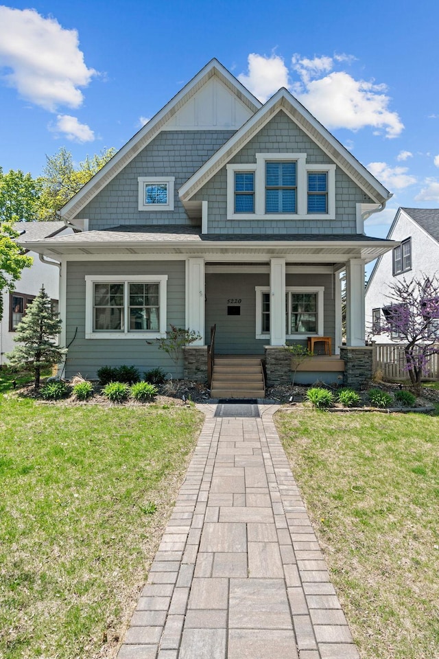 5220 Abbott Ave S, Minneapolis, MN 55410 - craftsman inspired home featuring a front lawn, a porch, and board and batten siding