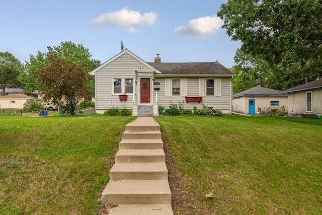 4559 Washington St NE, Columbia Heights, MN 55421 - bungalow featuring a front yard and a chimney