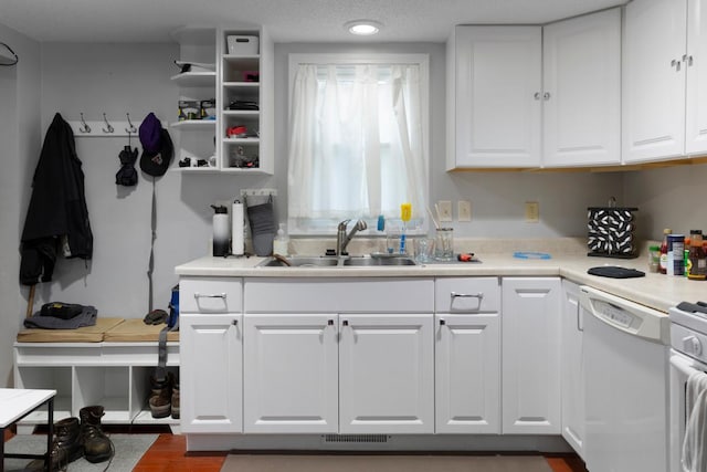 4559 Washington St NE, Columbia Heights, MN 55421 - kitchen featuring white dishwasher, white cabinets, light countertops, dark wood-style floors, and recessed lighting