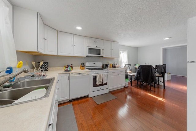 4559 Washington St NE, Columbia Heights, MN 55421 - kitchen with white appliances, white cabinets, recessed lighting, dark wood-type flooring, and a textured ceiling