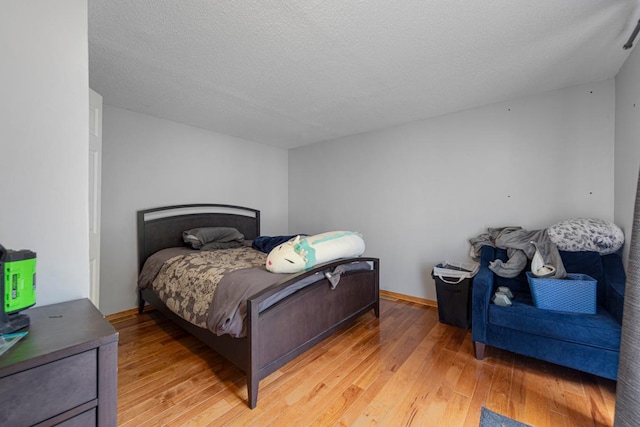 4559 Washington St NE, Columbia Heights, MN 55421 - bedroom with light wood-type flooring and a textured ceiling