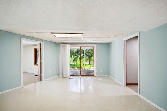 12005 27th Ave N, Plymouth, MN 55441 - spare room featuring baseboards, a drop ceiling, and tile patterned floors