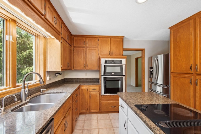 12005 27th Ave N, Plymouth, MN 55441 - kitchen with appliances with stainless steel finishes, a sink, light stone counters, and brown cabinets