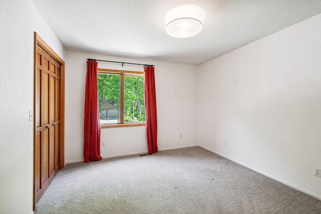12005 27th Ave N, Plymouth, MN 55441 - unfurnished bedroom with carpet, a textured ceiling, and baseboards