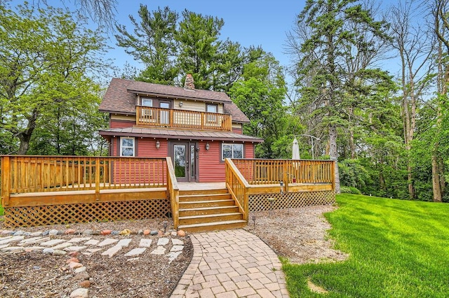 15947 Scandia Trl N, Scandia, MN 55073 - view of front of home featuring a front lawn, roof with shingles, a chimney, a wooden deck, and a balcony
