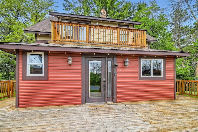 15947 Scandia Trl N, Scandia, MN 55073 - rear view of house with a deck, roof with shingles, a chimney, and metal roof