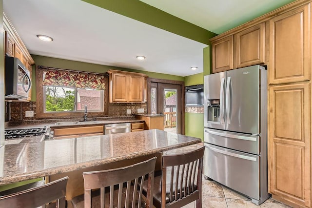 15947 Scandia Trl N, Scandia, MN 55073 - kitchen with appliances with stainless steel finishes, plenty of natural light, a sink, stone countertops, and recessed lighting