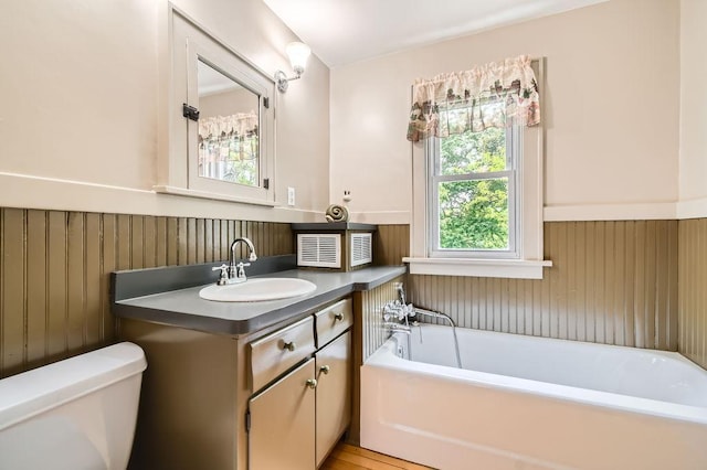 15947 Scandia Trl N, Scandia, MN 55073 - bathroom with a wainscoted wall, a garden tub, toilet, and vanity