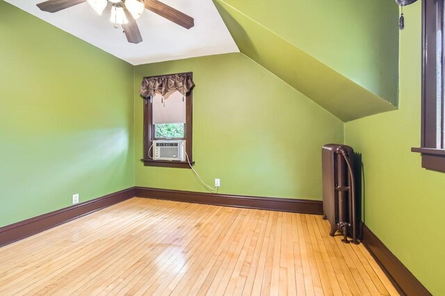 15947 Scandia Trl N, Scandia, MN 55073 - bonus room featuring lofted ceiling, hardwood / wood-style flooring, ceiling fan, cooling unit, and radiator heating unit