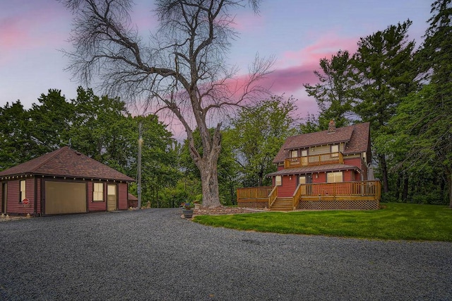 15947 Scandia Trl N, Scandia, MN 55073 - view of front of property featuring a front lawn, a detached garage, a wooden deck, a balcony, and a chimney