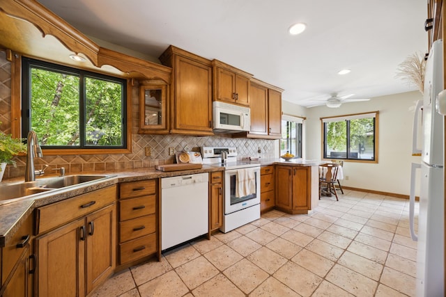 3704 Milton St N, Shoreview, MN 55126 - kitchen featuring white appliances, brown cabinets, tasteful backsplash, recessed lighting, and ceiling fan