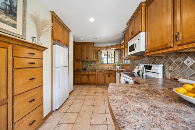 3704 Milton St N, Shoreview, MN 55126 - kitchen featuring white appliances, brown cabinets, decorative backsplash, and recessed lighting