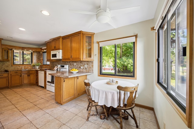3704 Milton St N, Shoreview, MN 55126 - kitchen featuring white appliances, brown cabinetry, healthy amount of natural light, backsplash, and recessed lighting