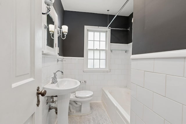 4150 Beard Ave N, Robbinsdale, MN 55422 - bathroom with tile walls, a tub to relax in, tile patterned flooring, a shower, and wainscoting
